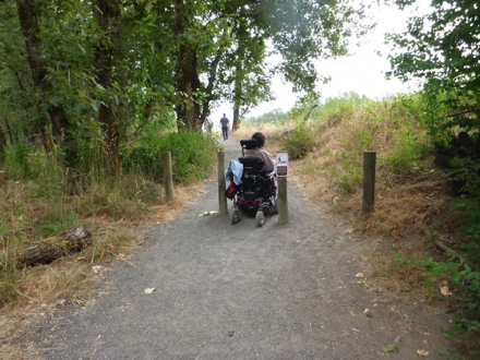 Trailhead to Confluence Trail – compacted gravel – encroaching grass on hard-packed soil surface